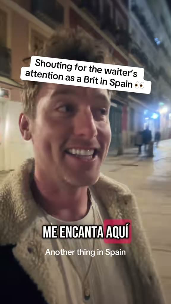 Chris on a street at night; the title card reads Shouting for the waiter's attention as a Brit in Spain