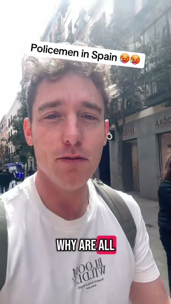 Chris on a street in Spain; the title card reads Policemen in Spain
